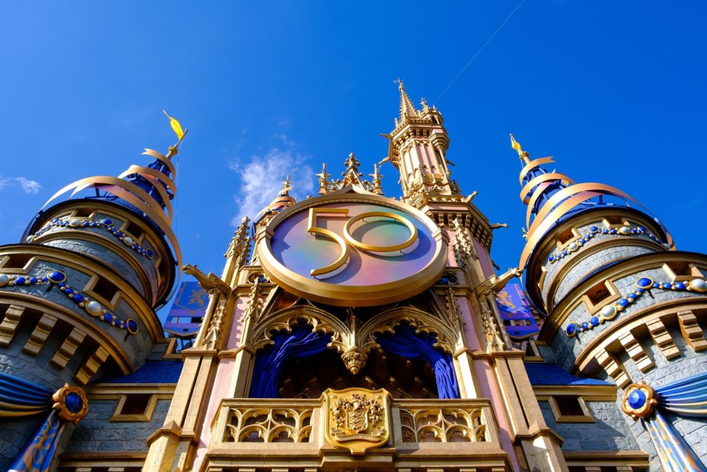 disney starbucks cups. this is an image of cinderella's castle decorated for its 50th anniversary.