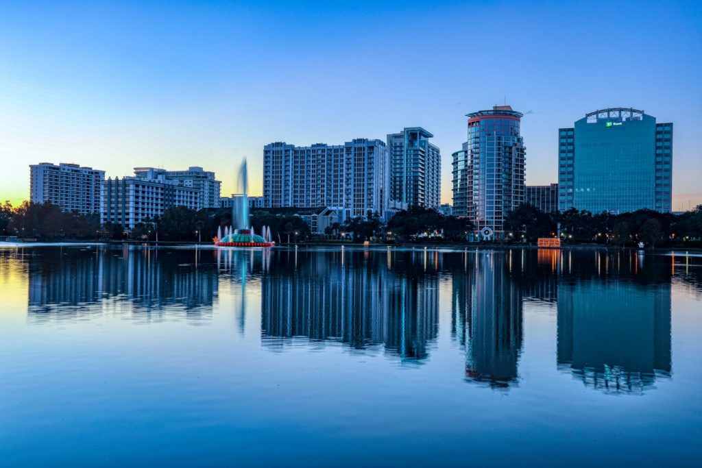 August Lake Nona and Orlando events. This is a view of Orlando across Lake Eola with the Orlando fountain with the city buildings in the background.